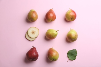 Ripe juicy pears with leaf on pink background, flat lay