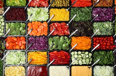 Photo of Salad bar with different fresh ingredients as background, top view