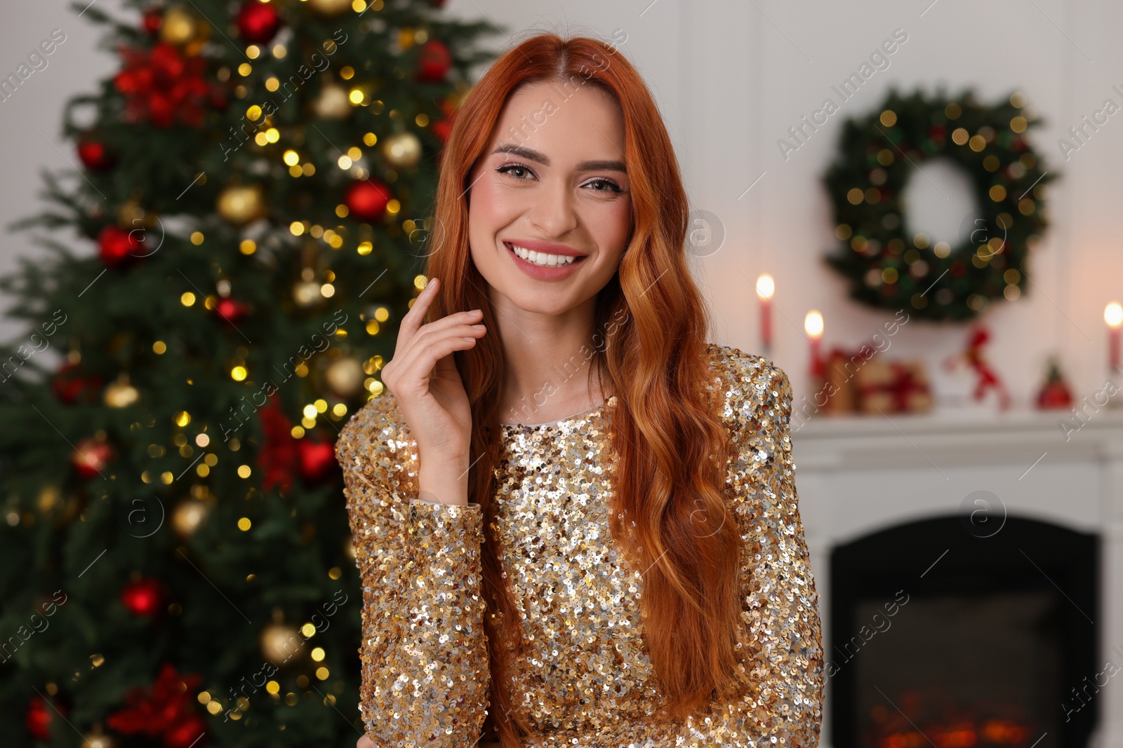 Photo of Happy young woman in room decorated for Christmas