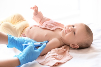 Photo of Doctor vaccinating baby in clinic