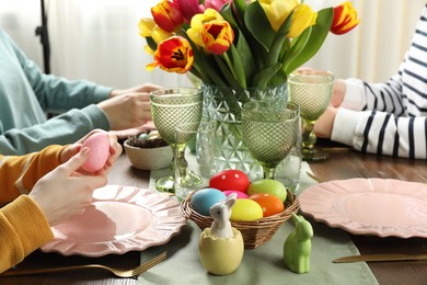 Photo of Festive table setting. Women celebrating Easter at home, closeup