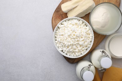 Different fresh dairy products on light table, flat lay. Space for text