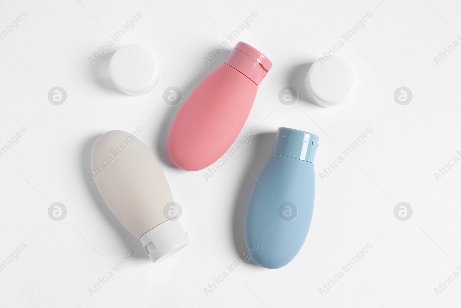 Photo of Cosmetic travel kit on white background, flat lay