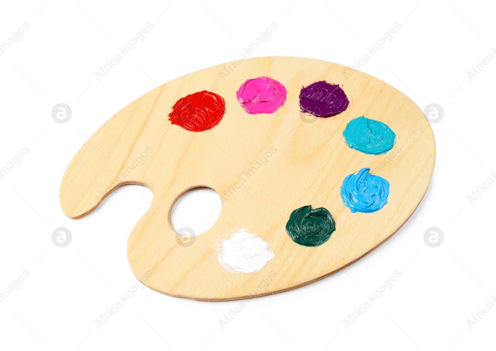 Photo of Wooden artist's palette with samples of paints isolated on white