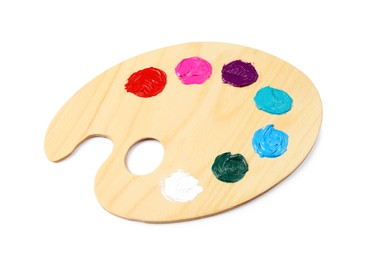 Photo of Wooden artist's palette with samples of paints isolated on white