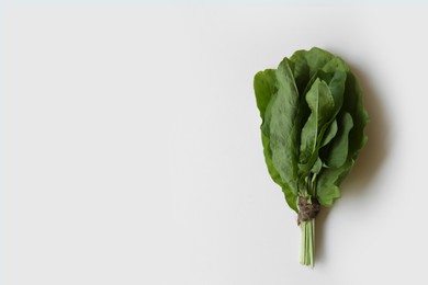 Photo of Bunch of sorrel on white wooden table, top view. Space for text