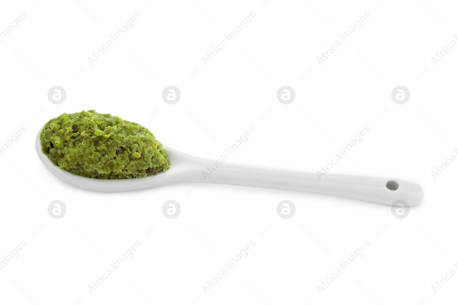 Photo of Spoon with delicious pesto sauce isolated on white