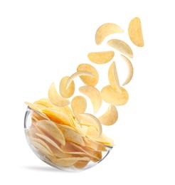 Fried crispy potato chips falling into bowl on white background