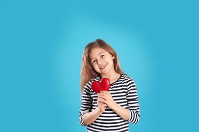 Photo of Portrait of girl with decorative heart on color background