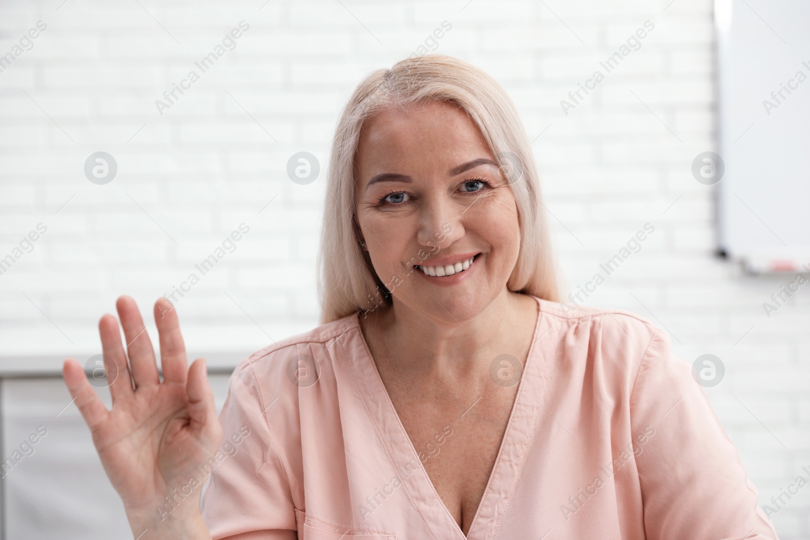 Photo of Mature woman using video chat indoors, view from web camera