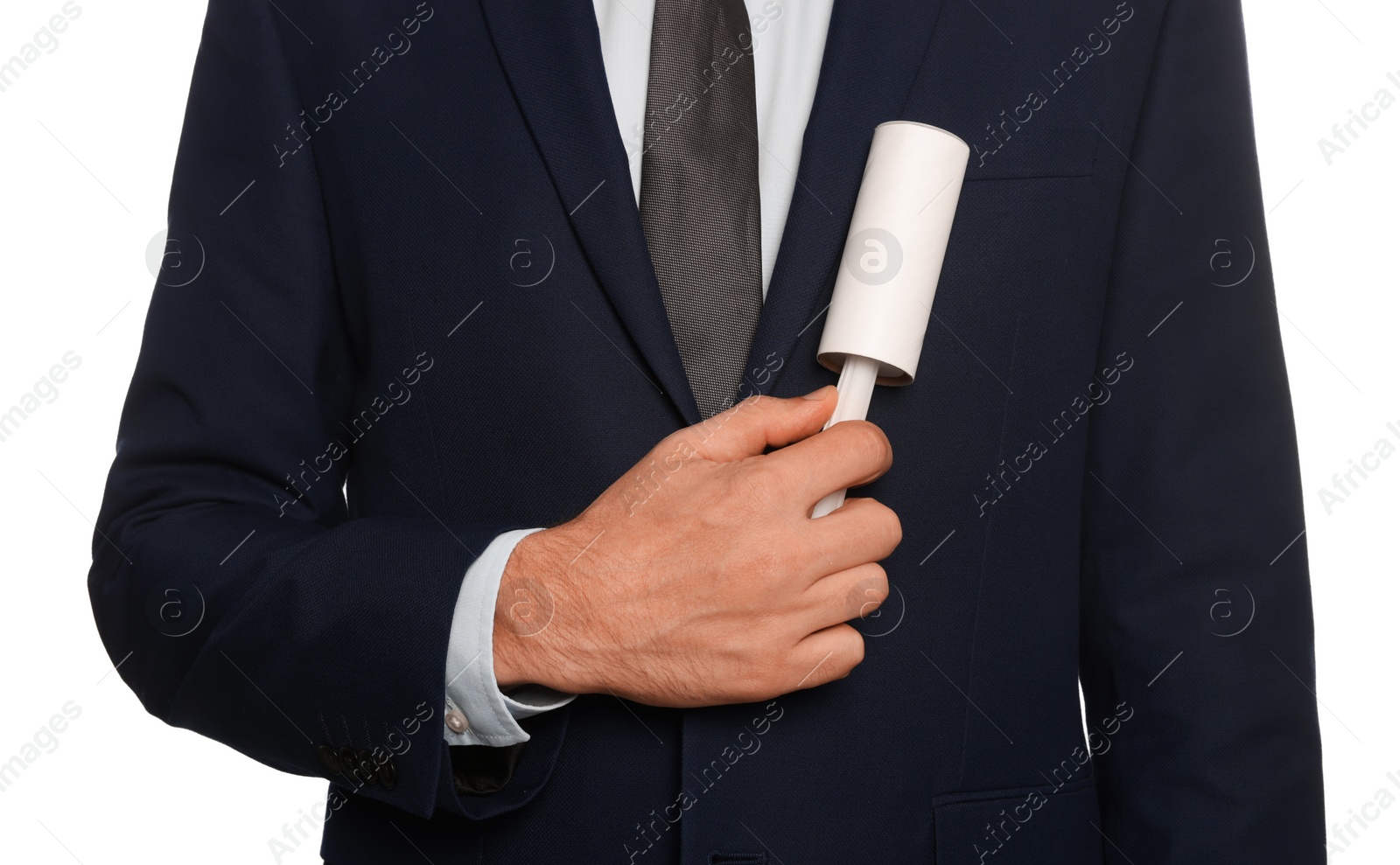 Photo of Man cleaning jacket with adhesive lint roller on white background, closeup