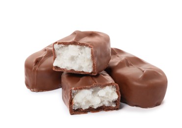 Photo of Delicious milk chocolate candy bars with coconut filling on white background