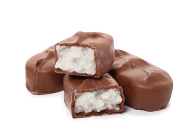 Delicious milk chocolate candy bars with coconut filling on white background