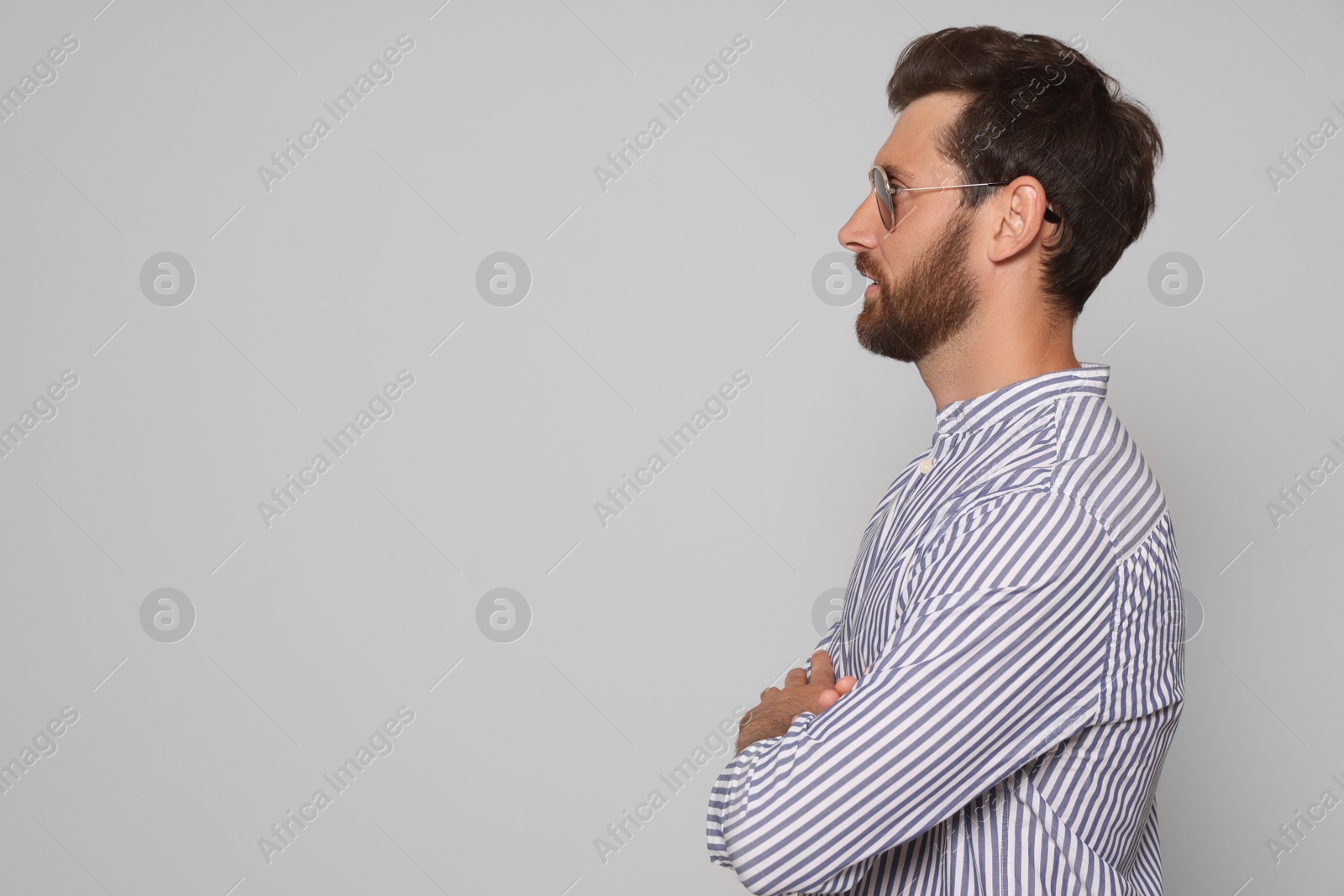 Photo of Profile portrait of bearded man with sunglasses on grey background. Space for text