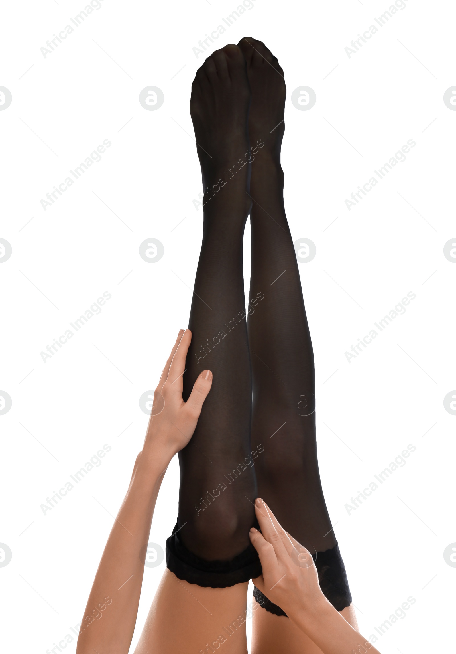 Photo of Young woman putting on stocking against white background, closeup