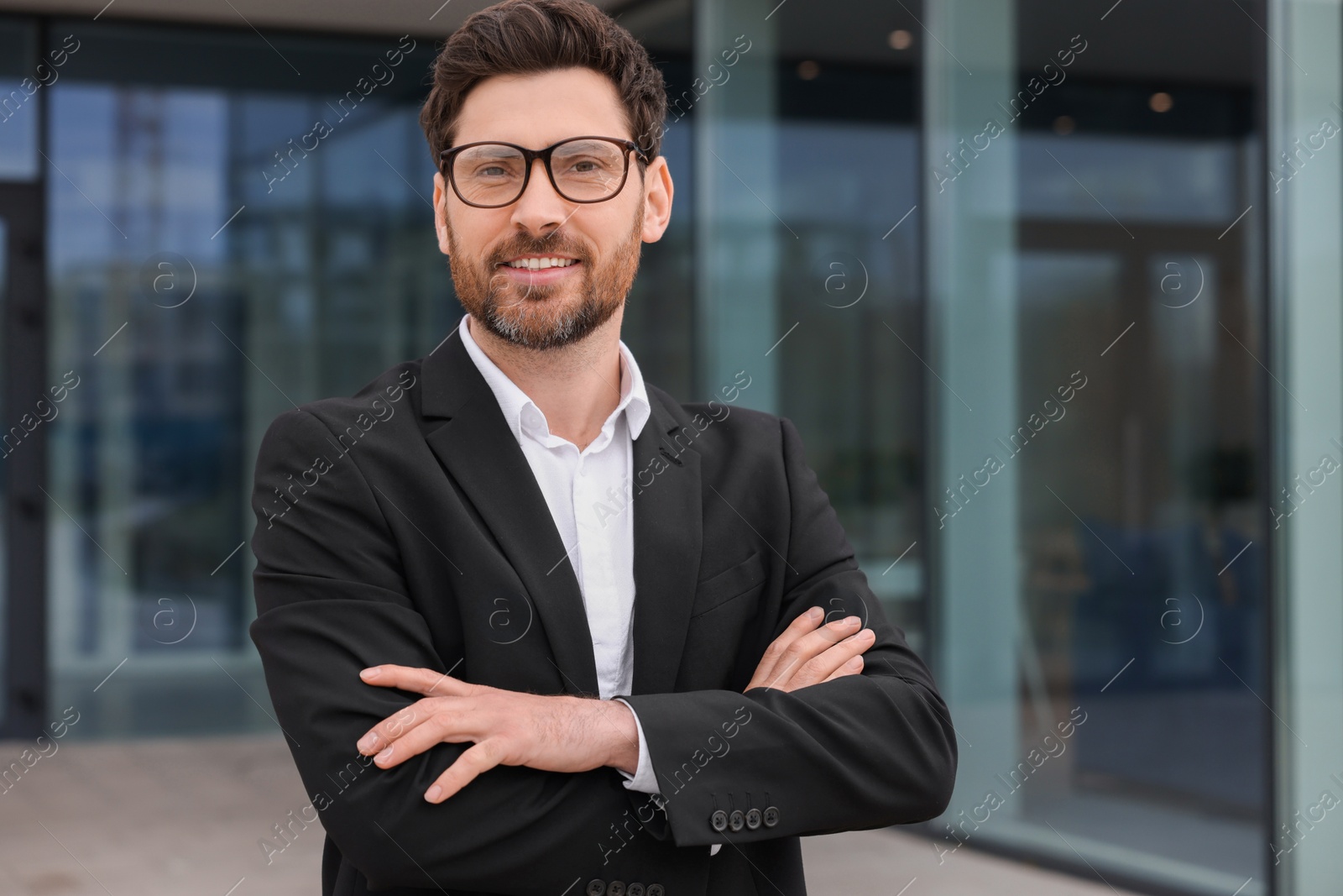 Photo of Happy real estate agent in suit outdoors