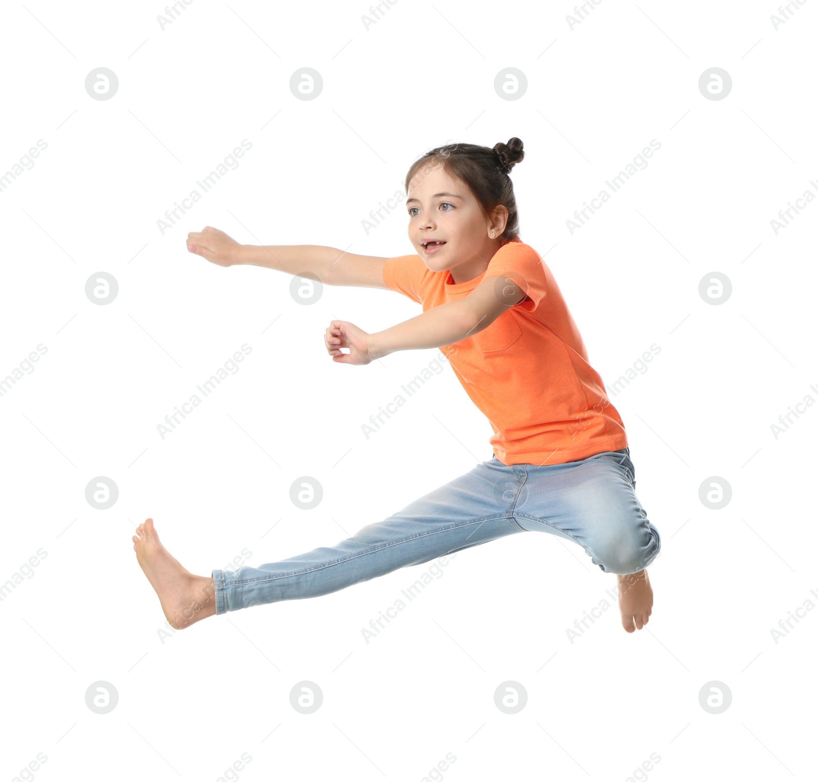 Photo of Cute little girl jumping on white background