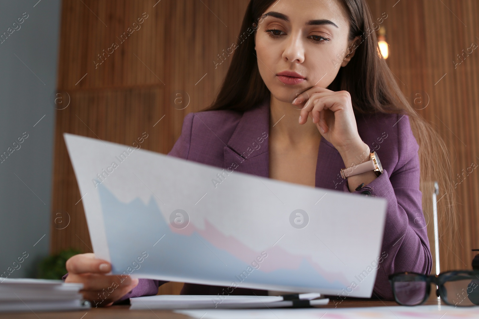 Photo of Beautiful businesswoman working with documents at table in office