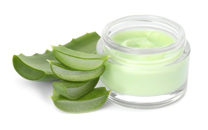 Photo of Jar of natural cream and cut aloe leaves isolated on white