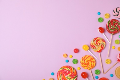 Photo of Flat lay composition with different candies and space for text on color background