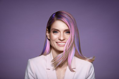 Image of Hair styling. Gorgeous woman with colorful hair on light purple background