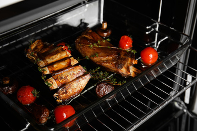 Photo of Delicious roasted ribs in oven. Yummy meat