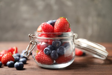 Photo of Mix of ripe berries on wooden table