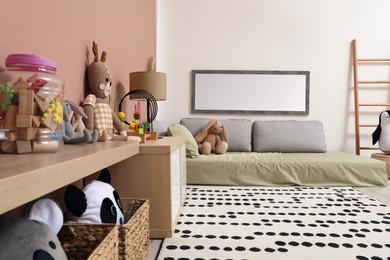 Photo of Montessori bedroom interior with floor bed and toys