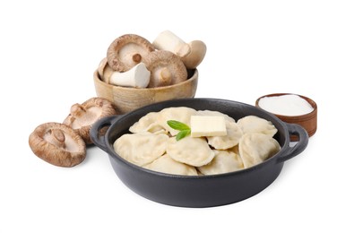Photo of Serving pan with delicious dumplings (varenyky), fresh mushrooms and sour cream isolated on white