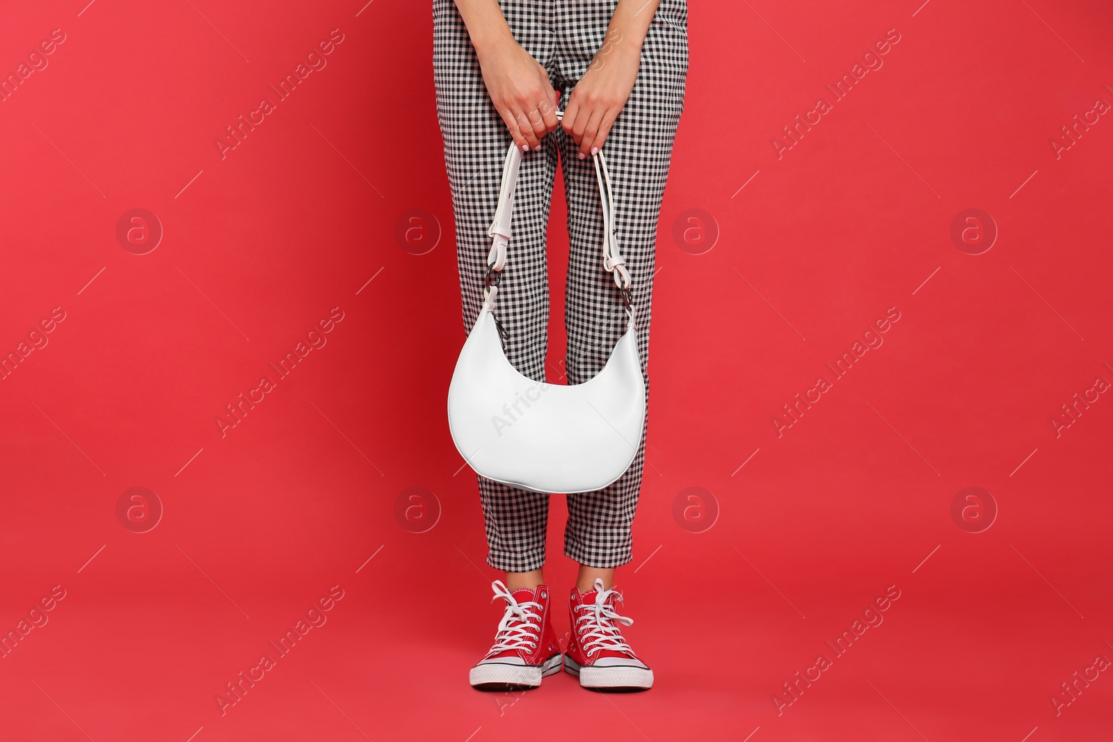 Photo of Woman with stylish bag on red background, closeup