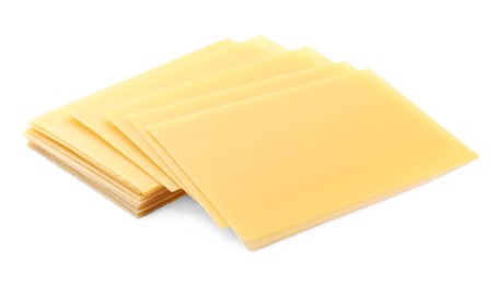 Stack of uncooked lasagna sheets isolated on white