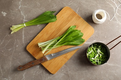 Photo of Flat lay composition with wild garlic or ramson on grey table
