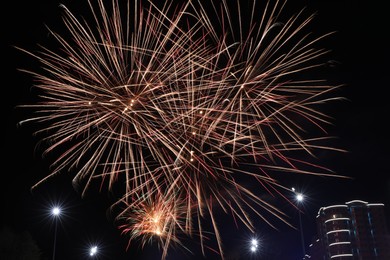 Photo of Beautiful fireworks lighting up night sky outdoors