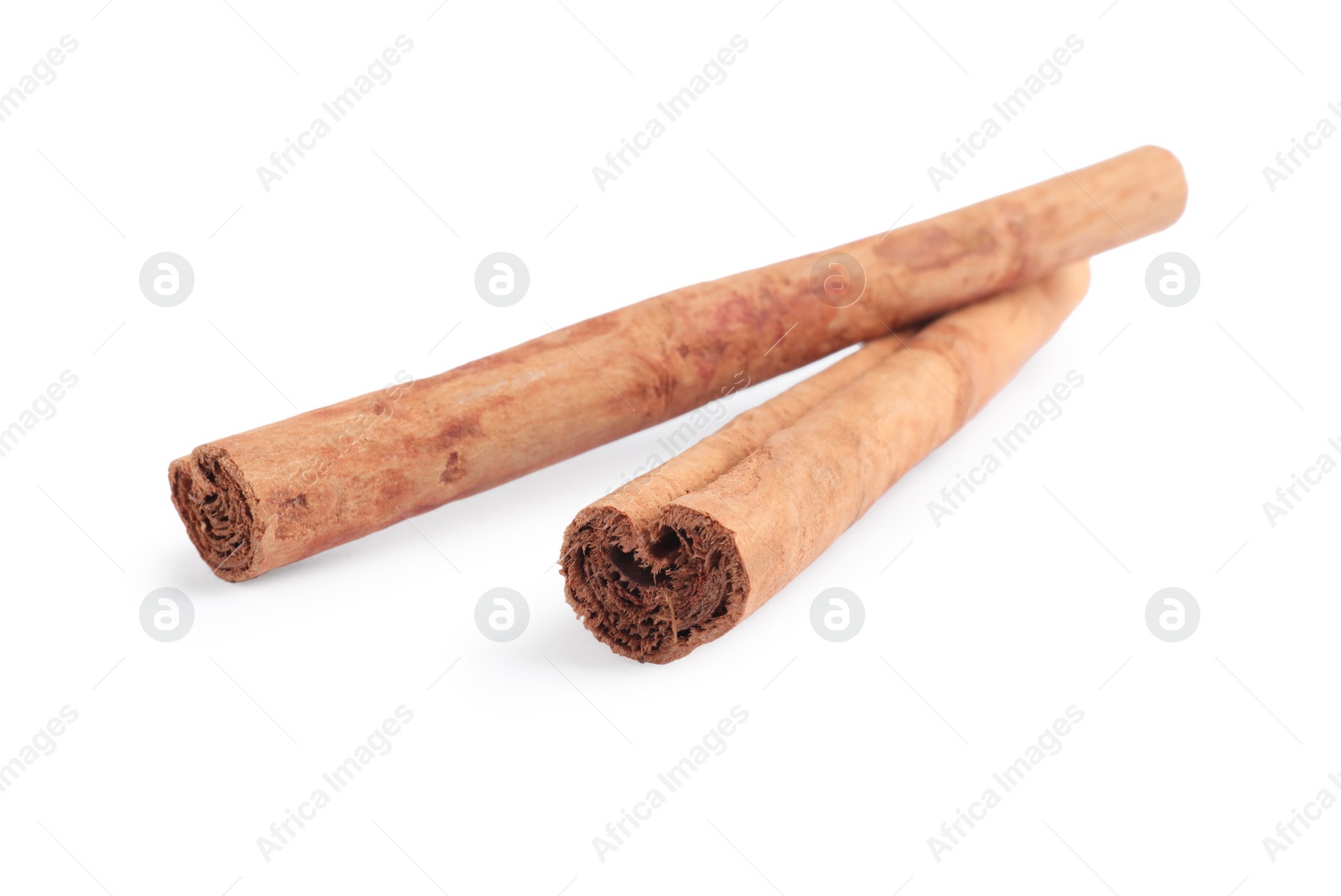 Photo of Dry aromatic cinnamon sticks isolated on white