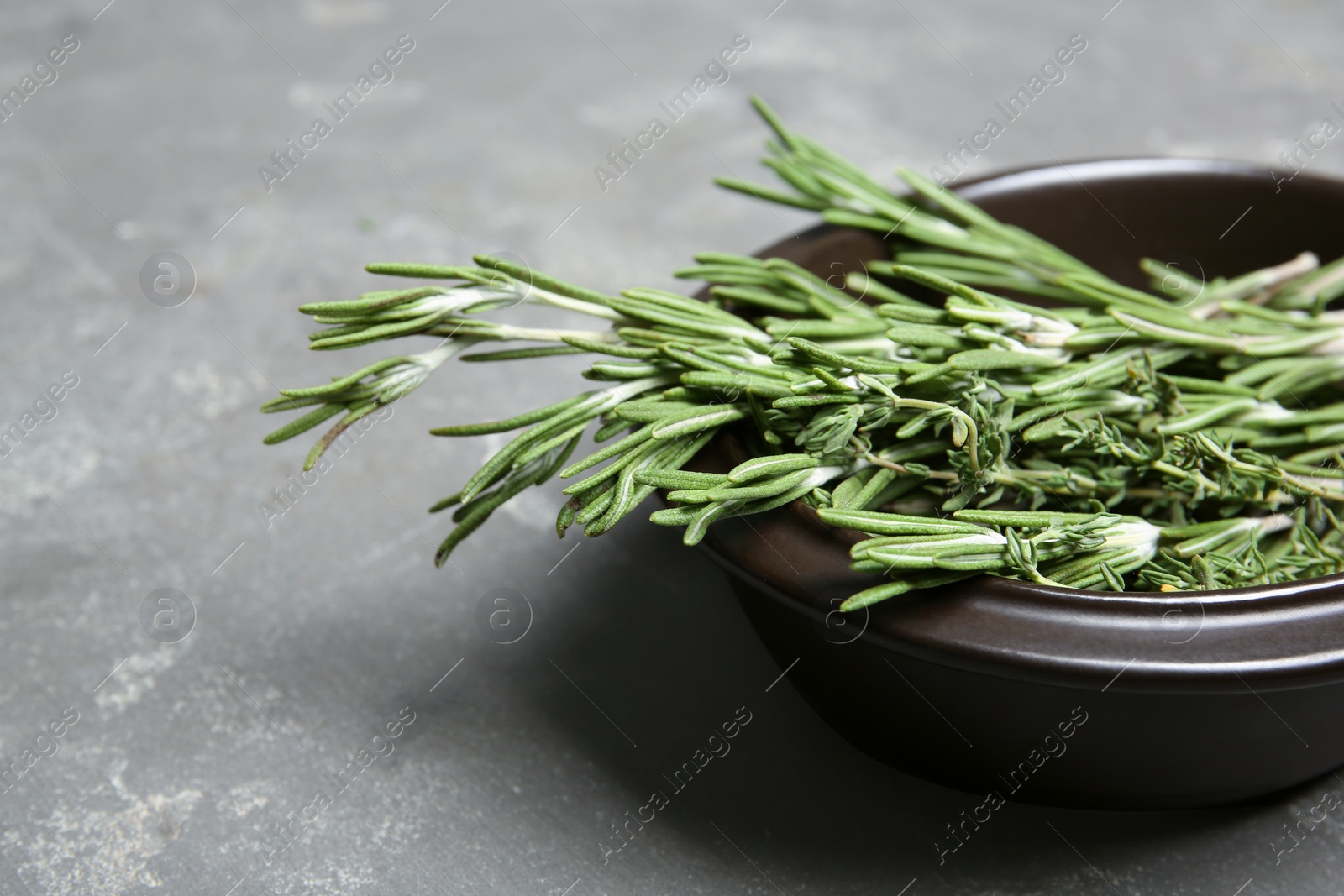 Photo of Plate with rosemary and thyme on table, closeup. Aromatic herbs