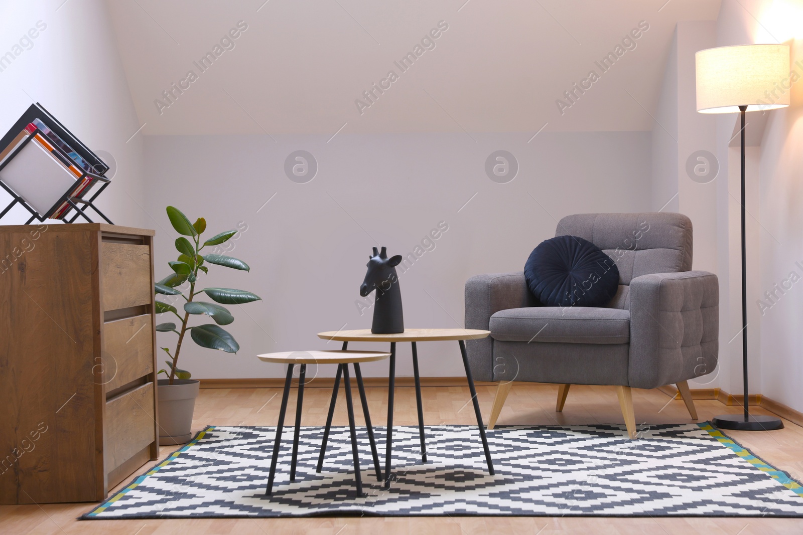 Photo of Attic room interior with slanted ceiling and furniture