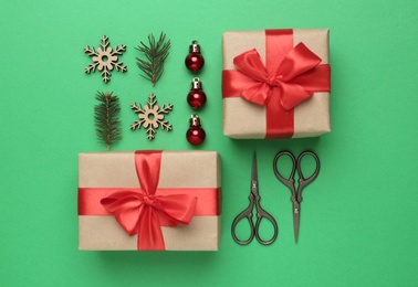 Photo of Flat lay composition with Christmas gifts on green background. Boxing day