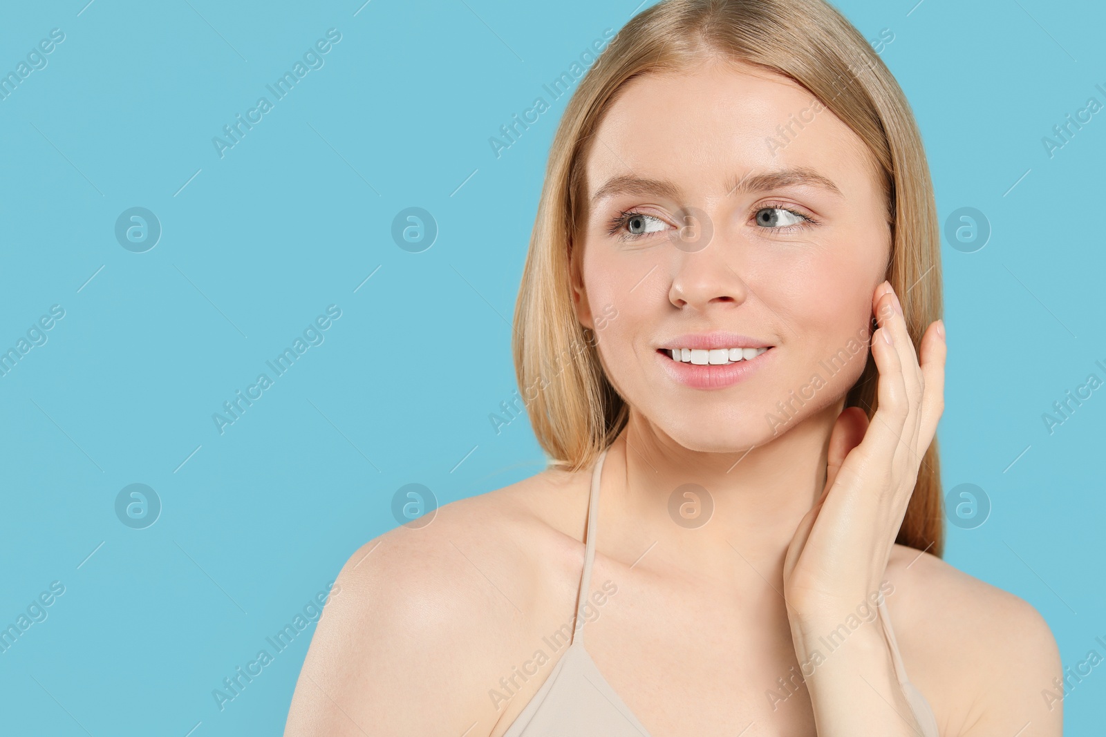 Photo of Beautiful young woman posing on light blue background, space for text