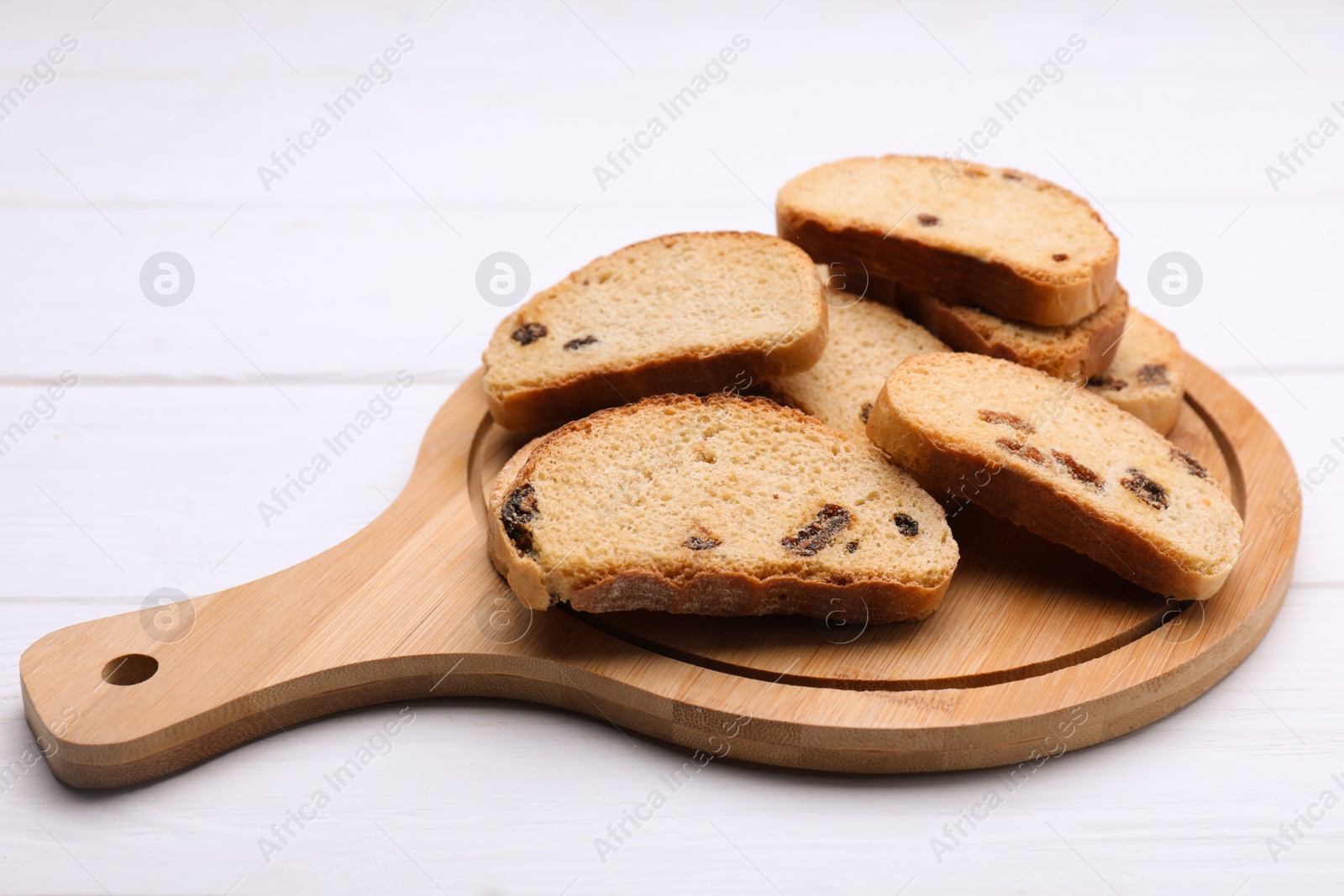 Photo of Sweet hard chuck crackers with raisins on white wooden table