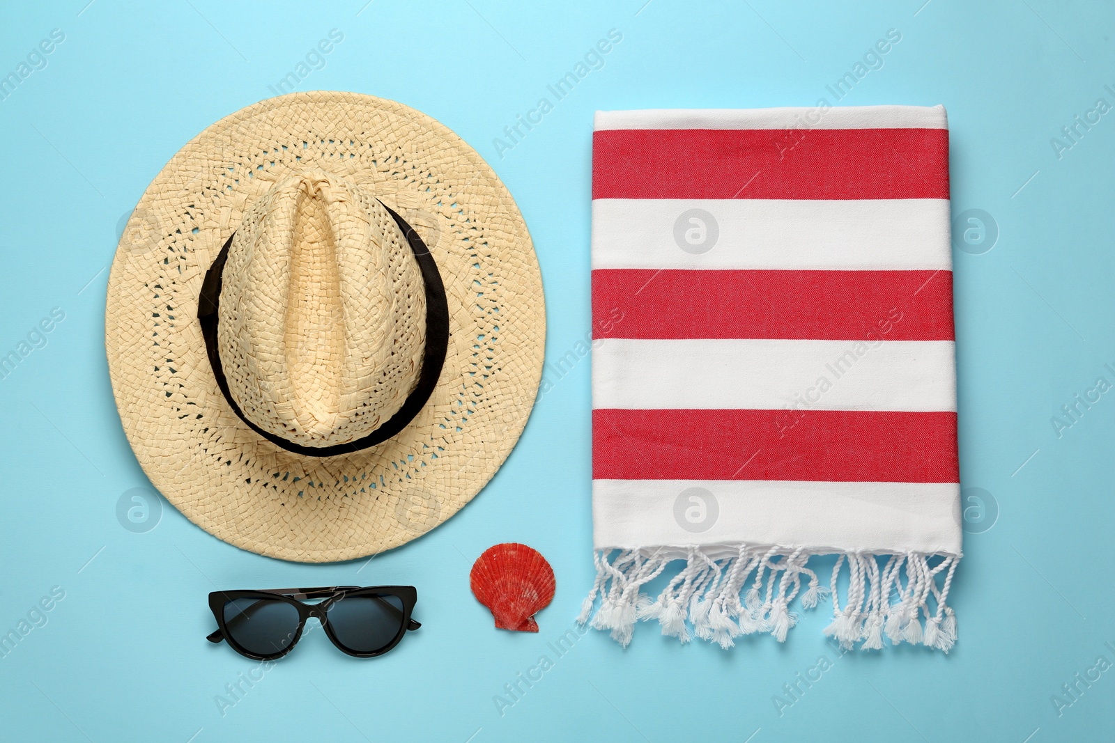 Photo of Flat lay composition with different beach objects on light blue background