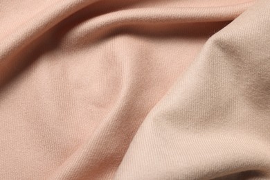 Photo of Texture of beige crumpled fabric as background, top view