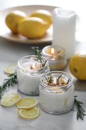 Natural homemade mosquito repellent candles and ingredients on white table