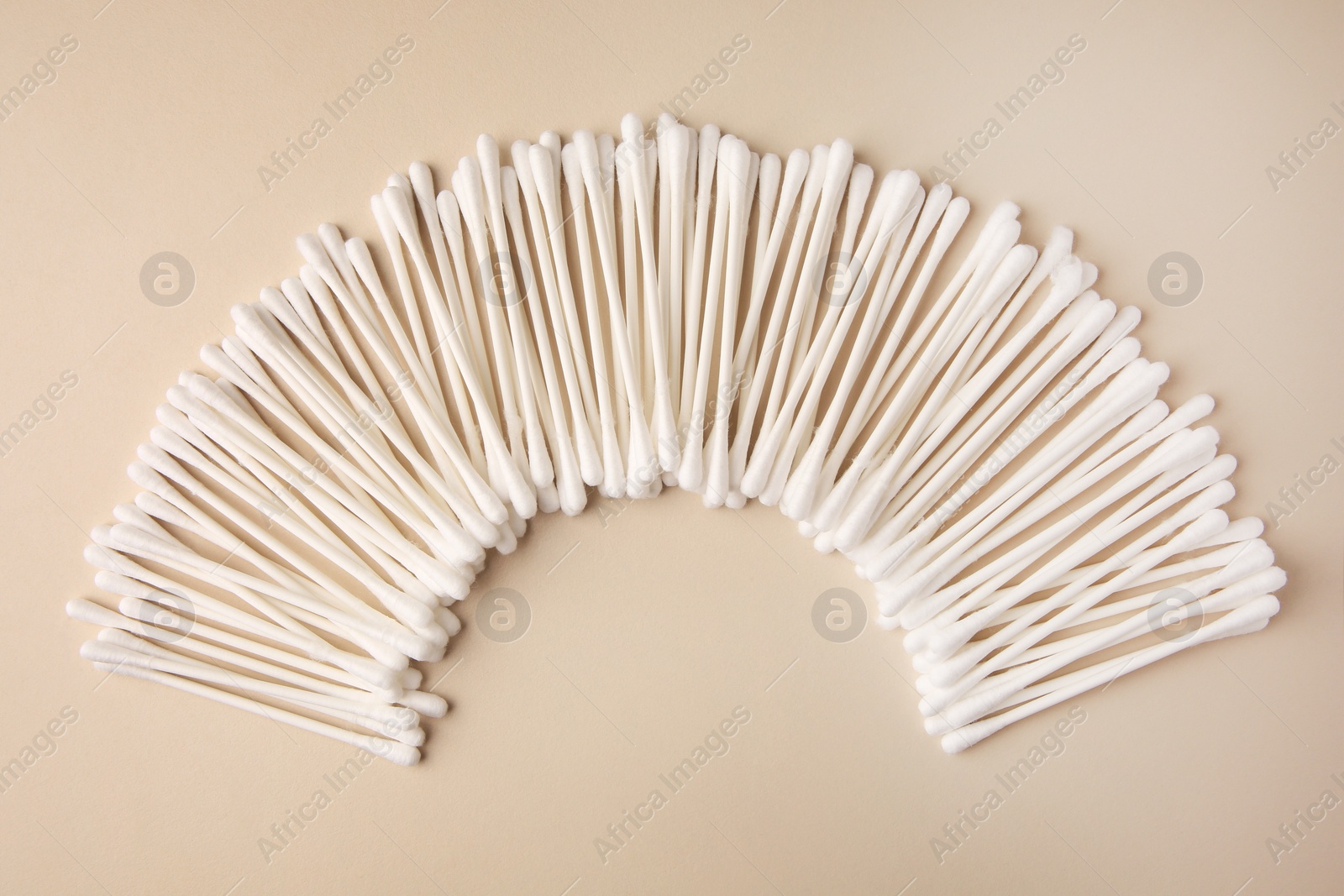 Photo of Many clean cotton buds on beige background, flat lay