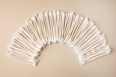 Photo of Many clean cotton buds on beige background, flat lay