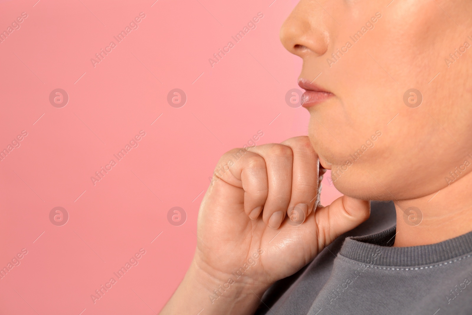 Photo of Woman with double chin on pink background, closeup. Space for text