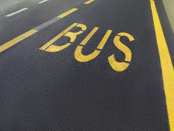 Photo of Bus stop pad on asphalt road on sunny day