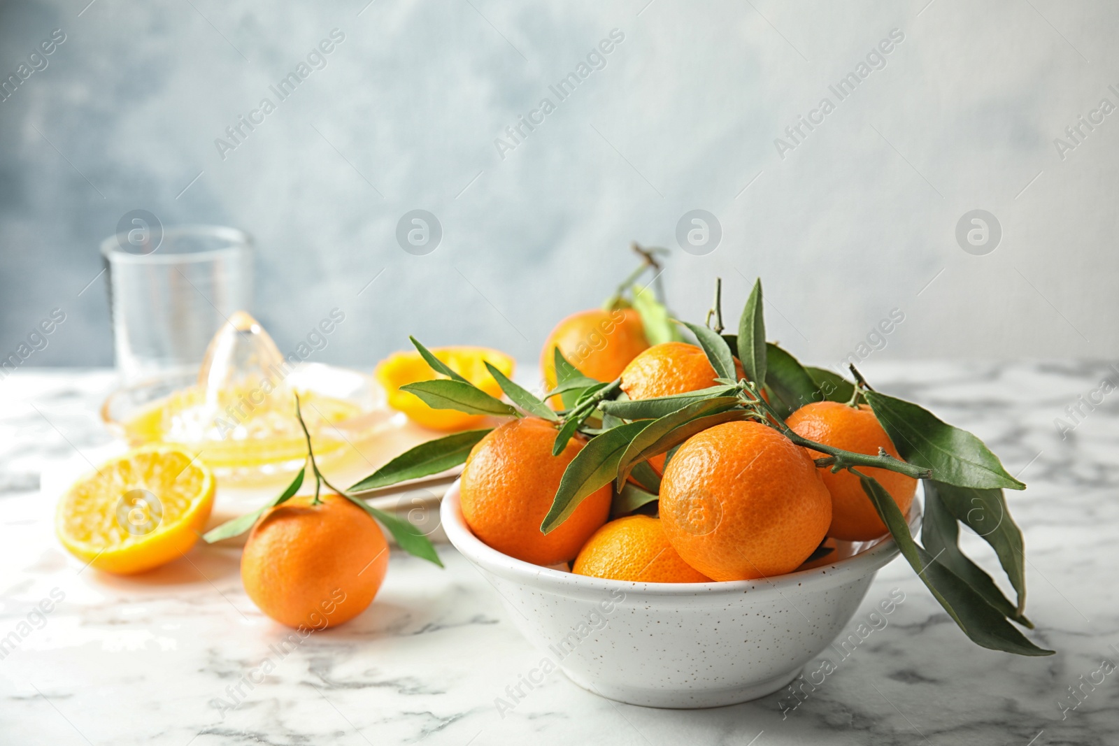 Photo of Bowl with ripe tangerines on table. Space for text