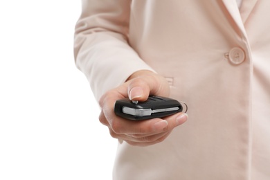 Woman holding car flip key isolated on white