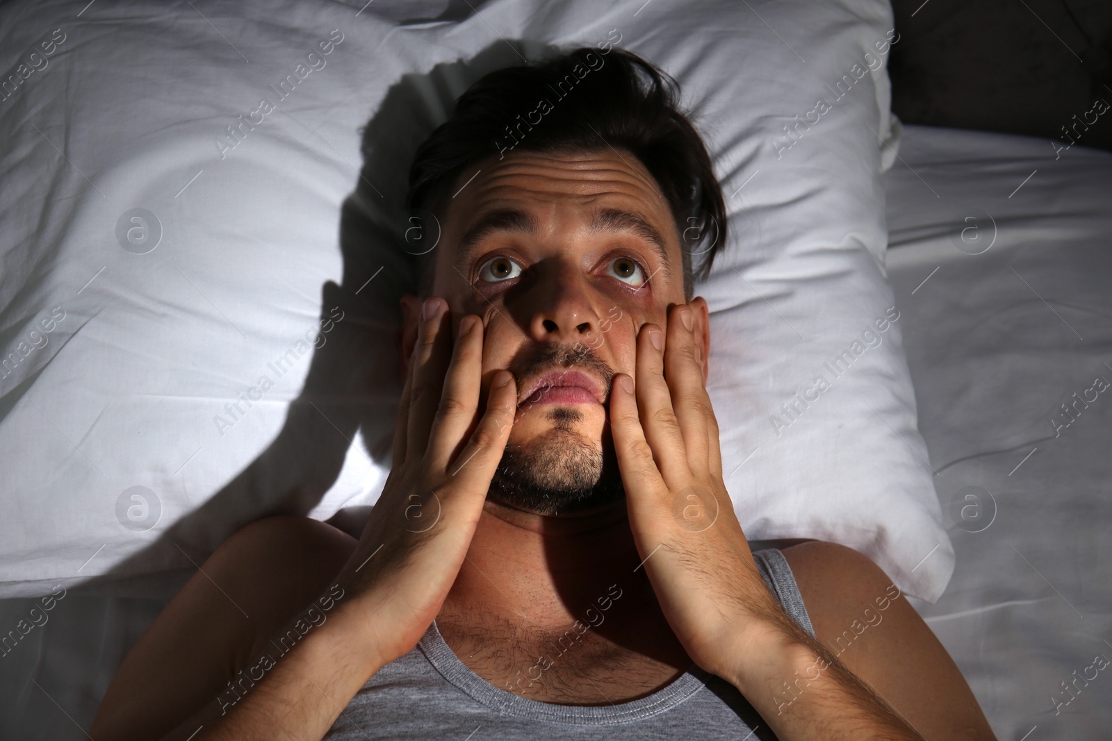 Photo of Man suffering from insomnia in bed at home