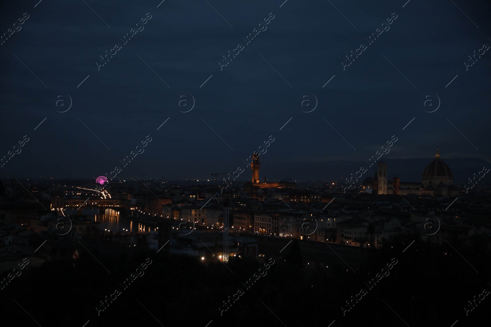 Photo of Picturesque view of city with buildings and bridge at night
